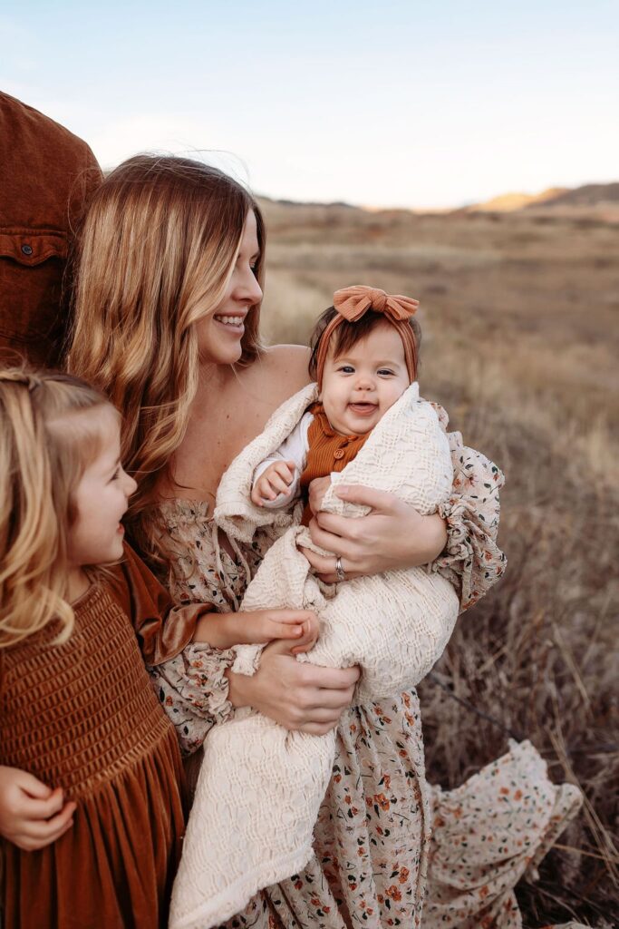 A perfect family portrait featuring warm fall colors captured by a Denver family photographer.