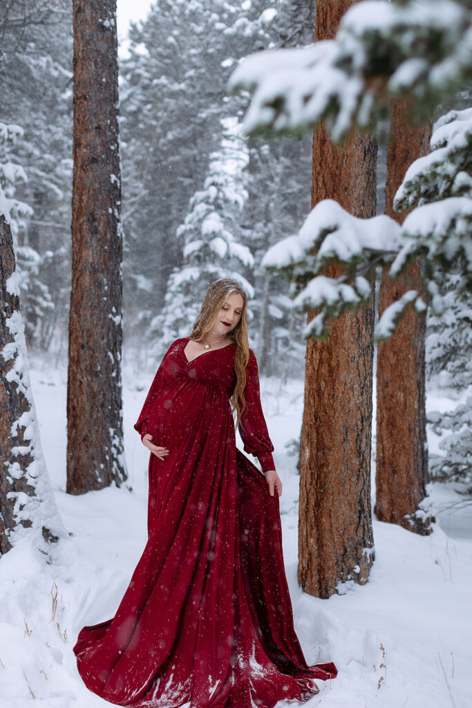 denver maternity photographer takes photos at couples home in lyons colorado during winter snowstorm for their pregnancy pictures