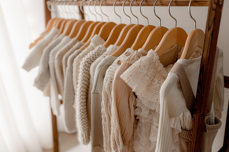 family wearing neutral outfits during a studio newborn photo session