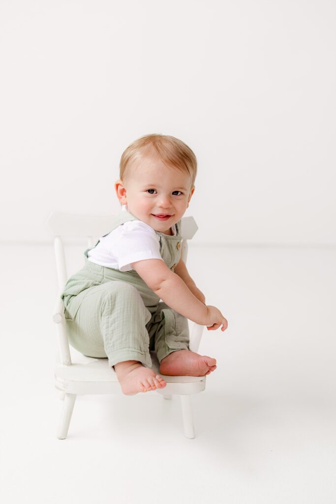 Loveland baby portraits during a simple and sweet cake smash session with natural wooden props.