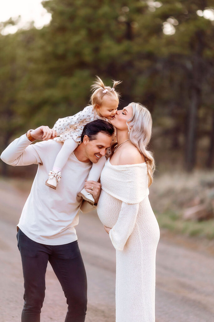 sunset maternity pictures at carter lake for family expecting their second baby