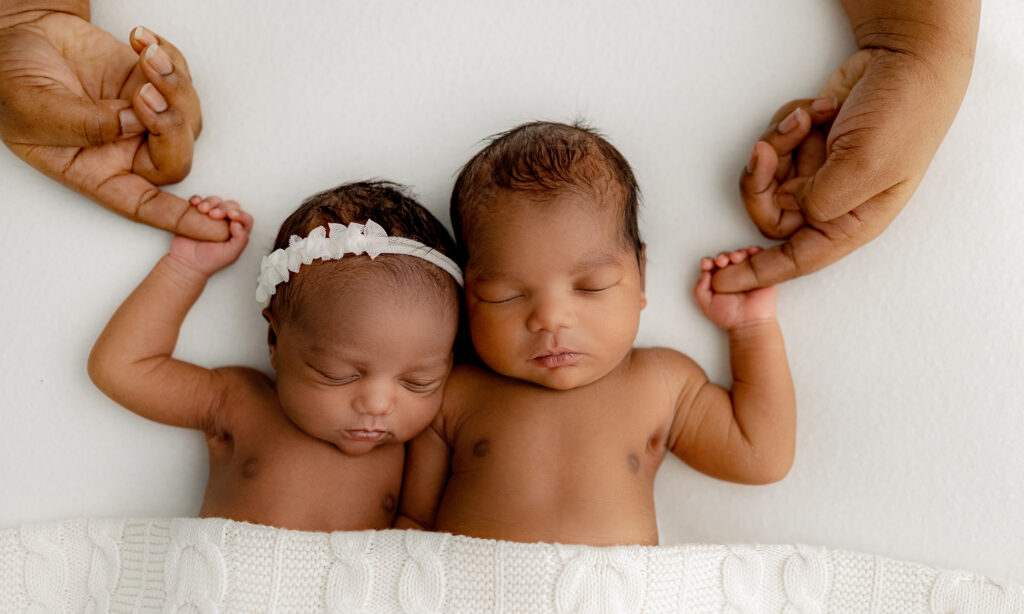close up of denver moms hands around his baby's fingers during their photo shoot in colorado when they are a week old