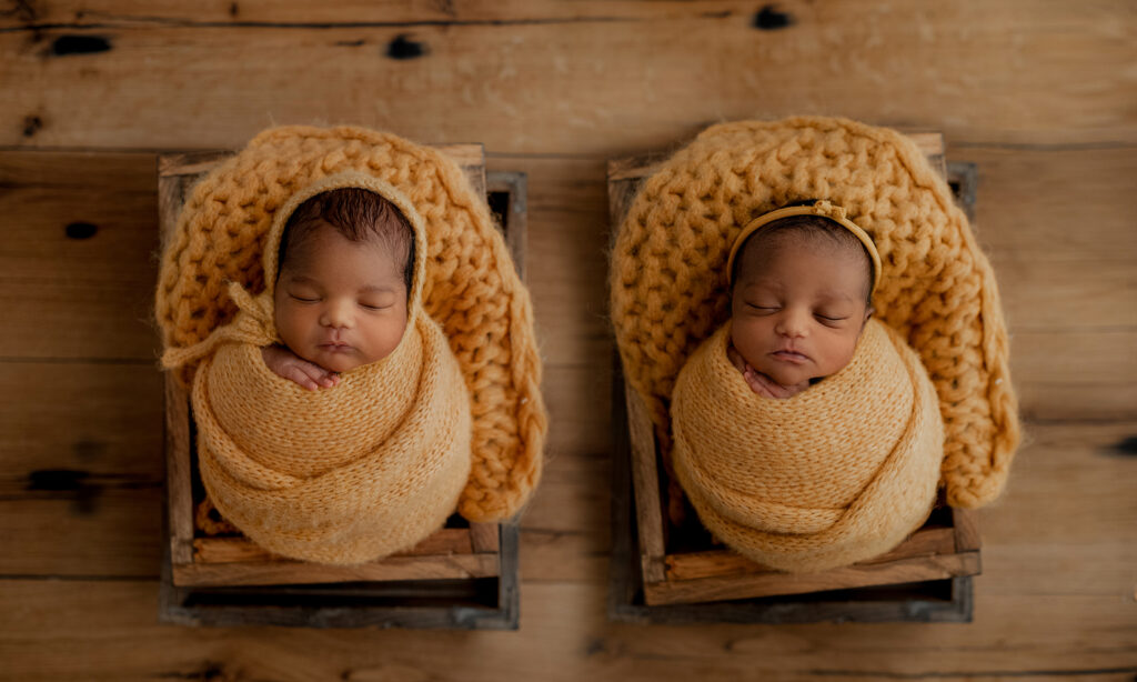 colorado newborn photographer poses twins during their photoshoot in her all white studio space 