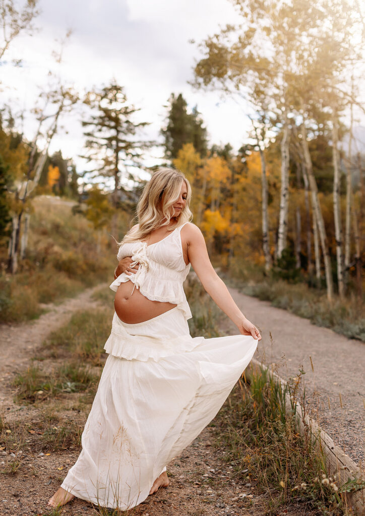 Maternity photos beside an alpine lake in Rocky Mountain National Park with sweeping Colorado mountain views.
