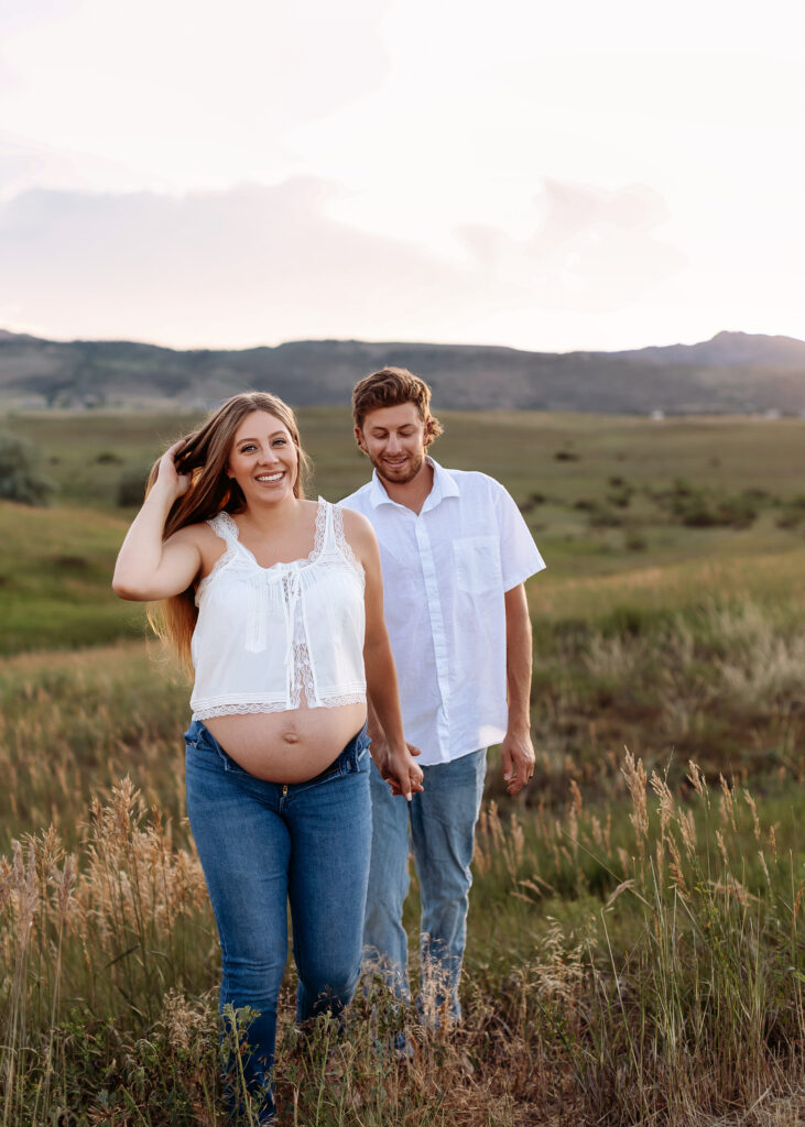 Maternity photo at Red Rocks with earthy tones and scenic Colorado landscape