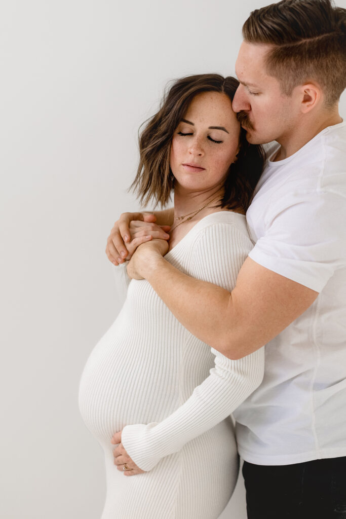 Studio maternity photography in Denver featuring a timeless, neutral studio setting