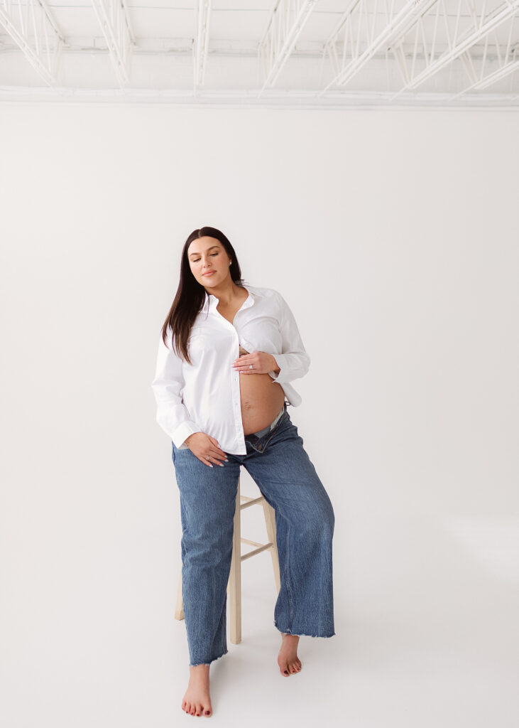 Editorial studio pregnancy photos highlighting natural movement, soft light, and connection