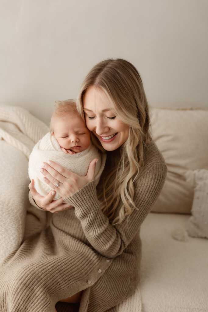 newborn photos Denver mother holding baby in studio neutral tones